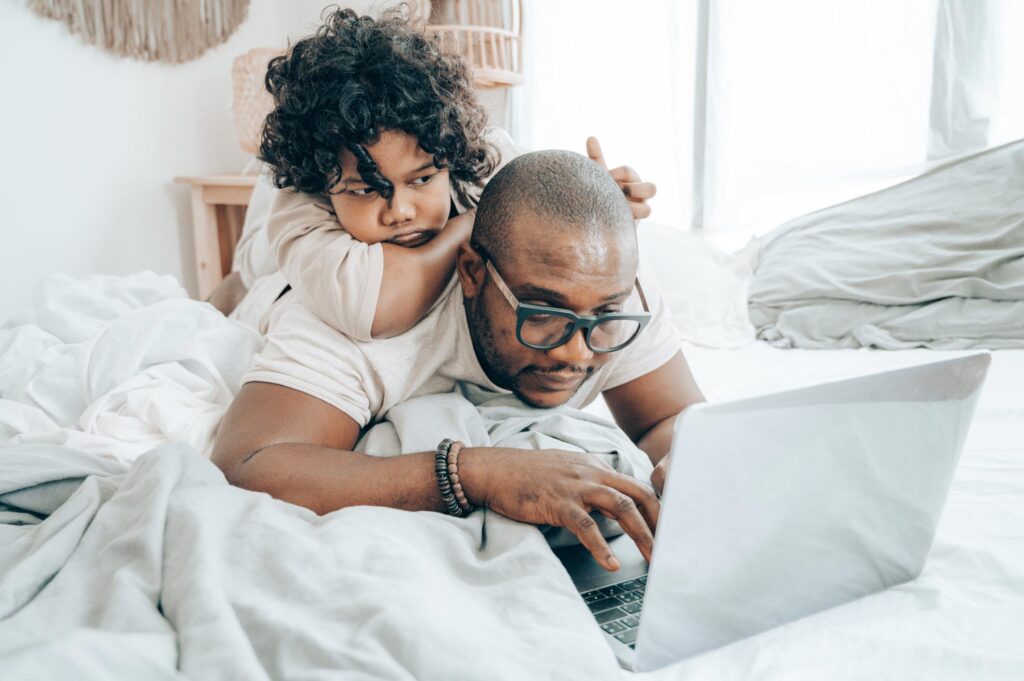 Photo by Ketut Subiyanto: https://www.pexels.com/photo/focused-black-man-with-kid-surfing-laptop-on-bed-4545775/